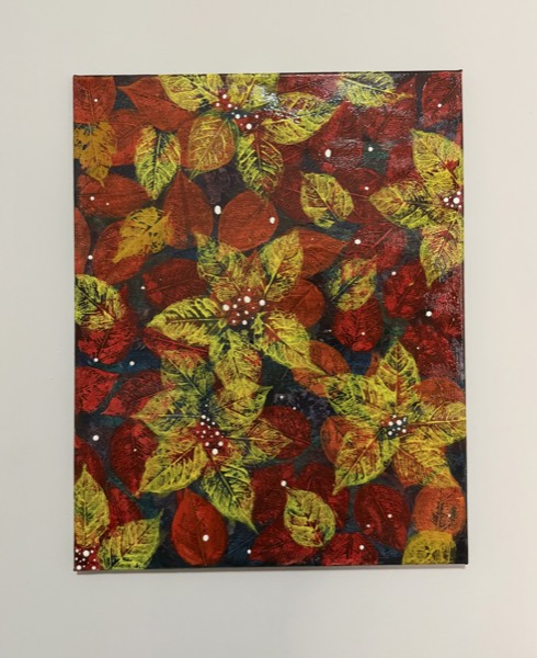 Painting of red, yellow and green leaf prints scattered on a dark blue background